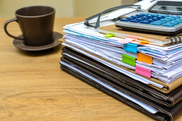 stack of folders and documents with coffee