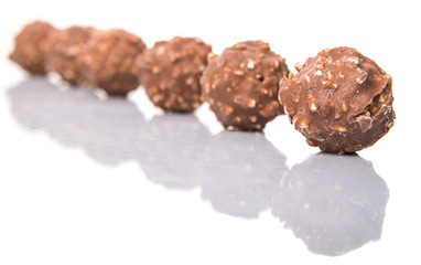 Chocolate balls with nuts over white background