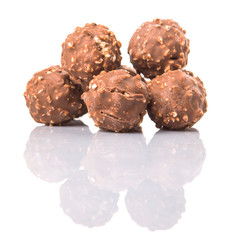 Chocolate balls with nuts over white background