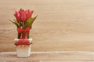 Flowers and pot on old wooden table