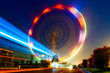 Night, a rotating Ferris wheel.