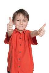 Young boy in the red shirt holds his thumbs up