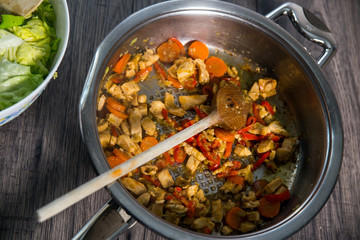 Sliced fresh vegetables with meat in pan