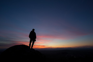 Fototapeta na wymiar silhouetted photographer in sunset sky