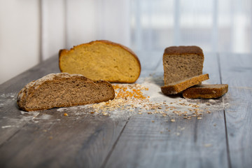 Group of different types of bread on old wooden table