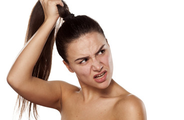 nervous young woman holding her ponytail