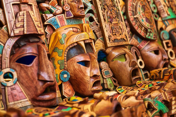 Mayan wooden handcrafted masks in a traditional Mexican market