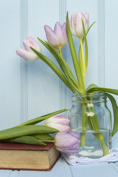 Beautiful Spring flower still life with wooden background and ho