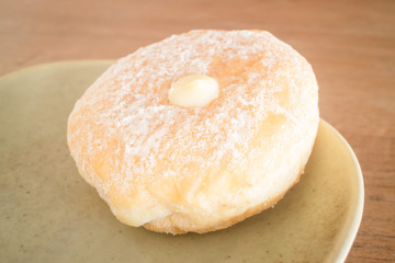 Cream donut on vintage background