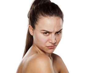 Naklejka premium scowling dissatisfied young woman without makeup