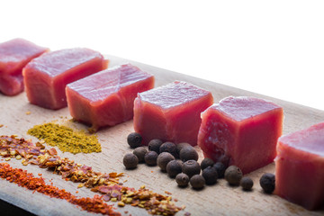 raw meat and spices on wooden stand