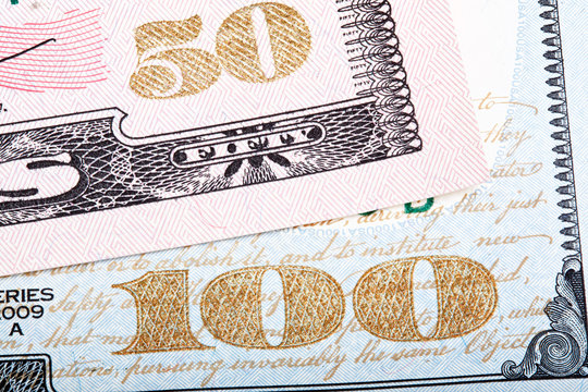 Stacked photo. Detail of new design of 100 and 50 dollars.