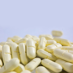 Heap of yellow pills and a lot of copyspace