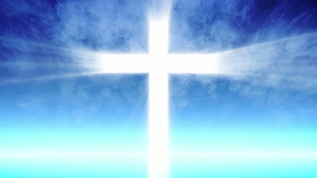 Cross of Christ ray beams and blue sky background