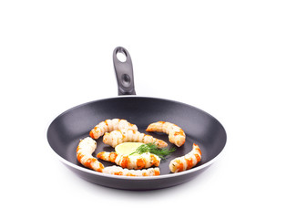 Tiger shrimps on black pan.