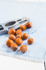 Organic hazelnut on white wooden table background