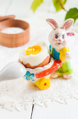 Easter rabbit and egg on white wooden table background