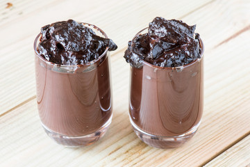 chocolate  pudding glasses on wooden board