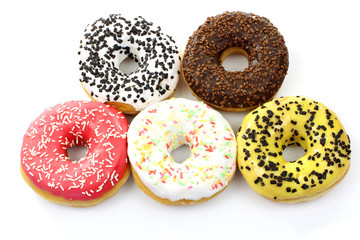 colorful glazed donuts with sprinkles on a white background