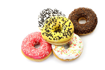 colorful glazed donuts with sprinkles on a white background