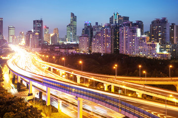 Fototapeta na wymiar illuminated traffic on elevated expressway in modern city.