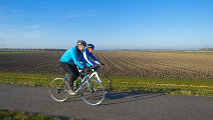 Fototapeta na wymiar Cyclists on a countryside road in winter