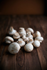 Fototapeta na wymiar White mushrooms on wood table