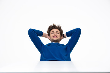 Happy businessman relaxing at the table over white background