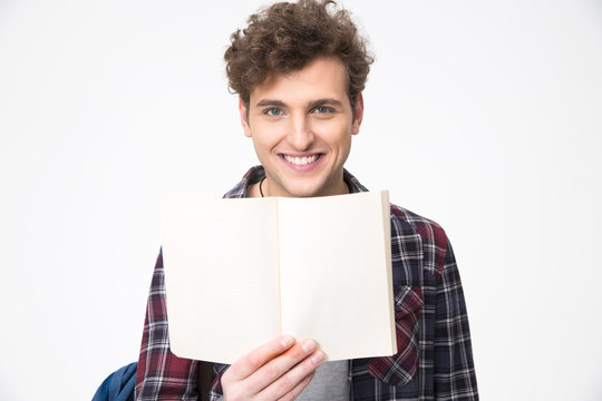 Happy young male student holding blank notebook