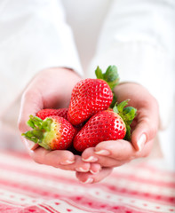 Hands Holding Strawberries