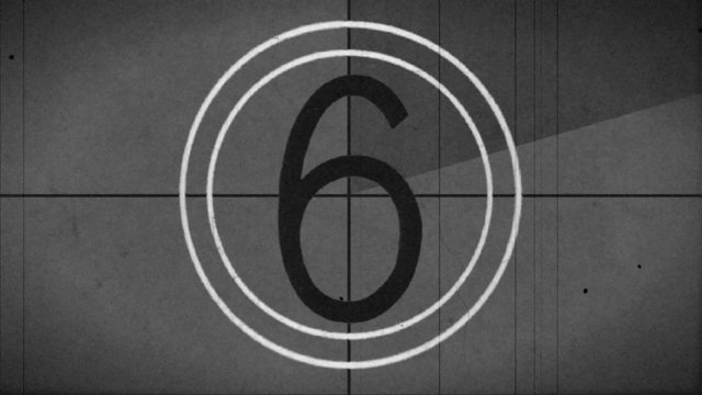 Old style film leader with the crackle of the audio lead and syncing beeps.