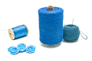 spools of blue thread and ball of yarn