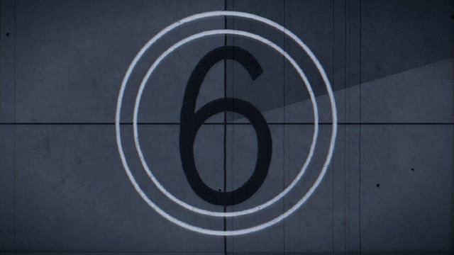 Old style film leader with the crackle of the audio lead and syncing beeps.