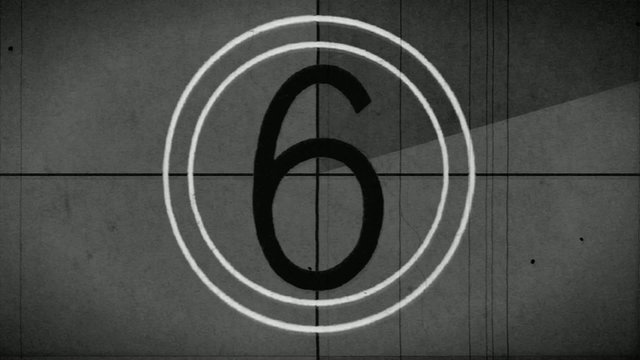 Old style film leader with the crackle of the audio lead and syncing beeps.