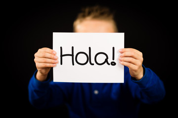 Child holding sign with Spanish word Hola - Hello © Mikkel Bigandt