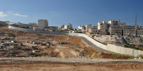 Israeli security fence near Jerusalem separating west bank.