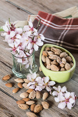 Almonds and flower tree in a wooden background