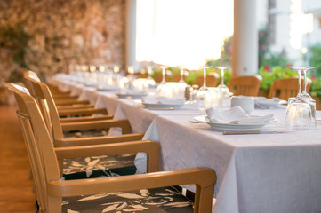 Setout table with tableware in modern restaurant.