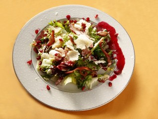 vegetable salad with pork bacon and pomegranate juice