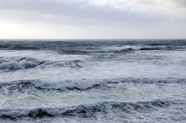 pattern of big waves at sea in cloudy sky