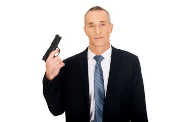 Portrait of serious mafia agent with handgun