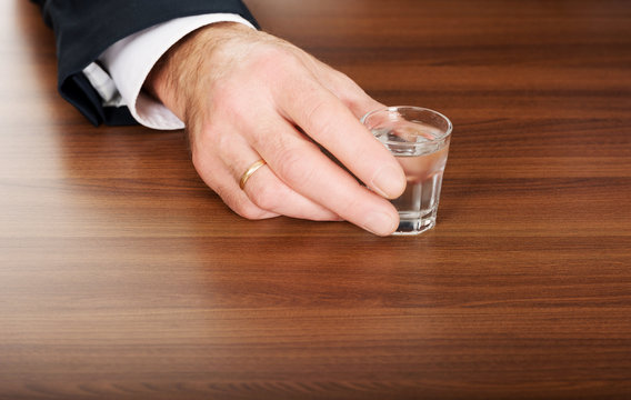 Male hand with a glass of alcohol