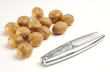 Nutcracker and chestnuts isolated on white