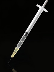 Medical syringe on black background