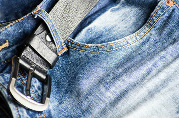 Detail of nice blue jeans with leather belt