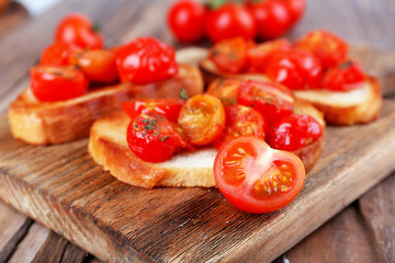 Slices of white toasted bread with canned tomatoes
