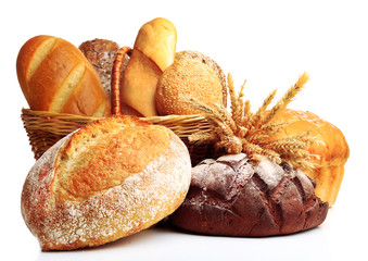 Fresh bread with wheat in wicker basket isolated on white