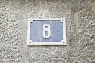 Number eight on the wall of a house
