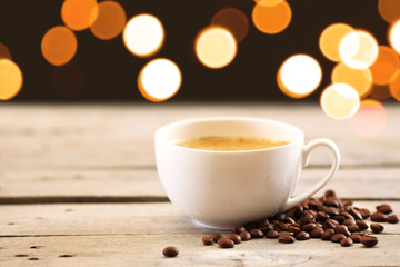 Cup of coffee on table on brown background