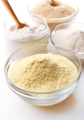 Different types of flour in bowls close up